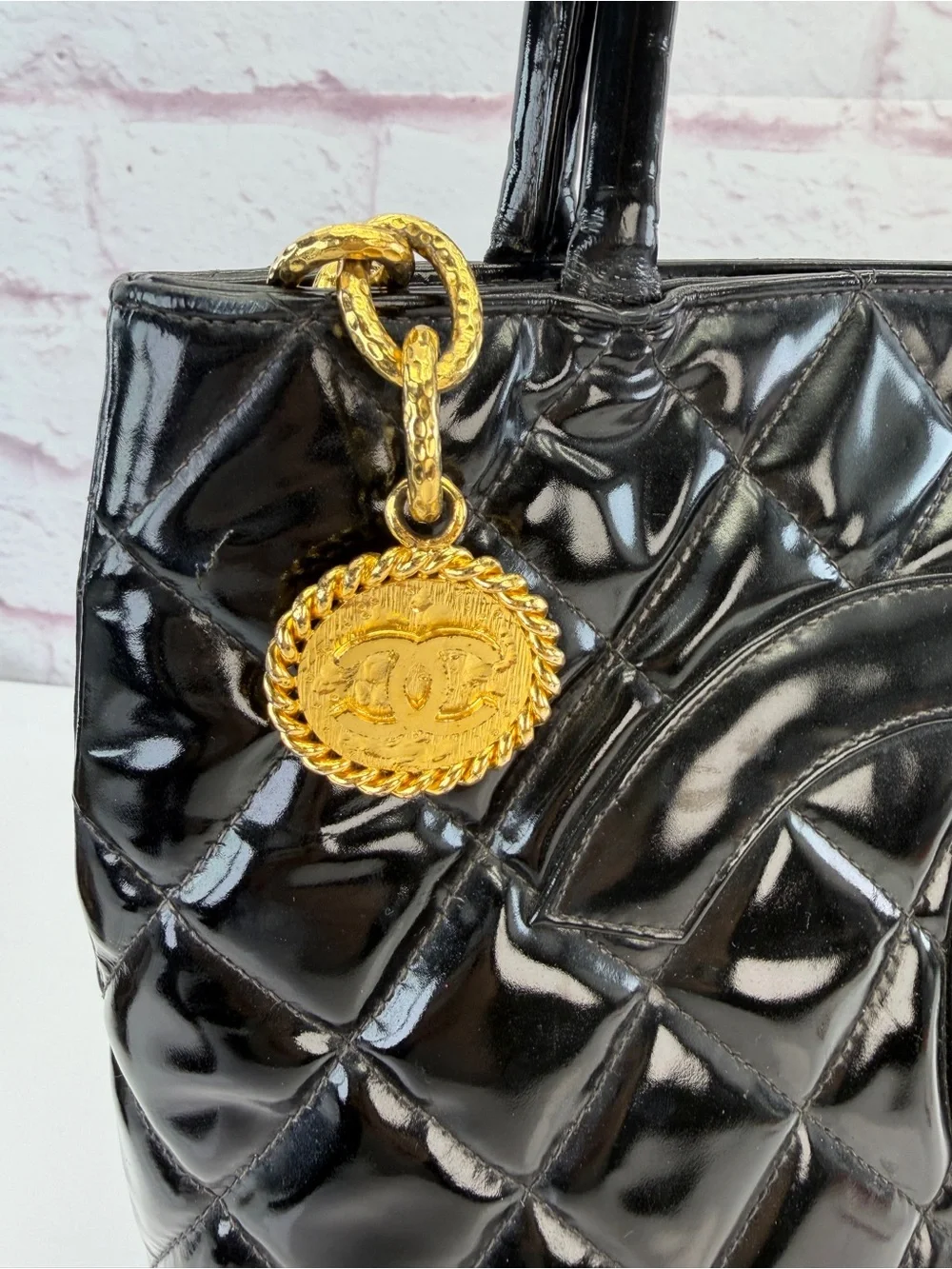 CHANEL Black Quilted Patent Leather Tote with Gold Medallion Charm